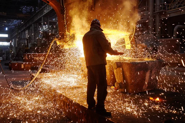 Steelmaker at ingot casting. Electric arc furnace shop EAF. Metallurgy.