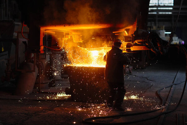 Steelmaker at ingot casting. Electric arc furnace shop. Metallurgy. 