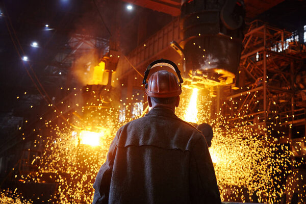 Steelmaker at ingot casting. Electric arc furnace shop EAF. Metallurgy.