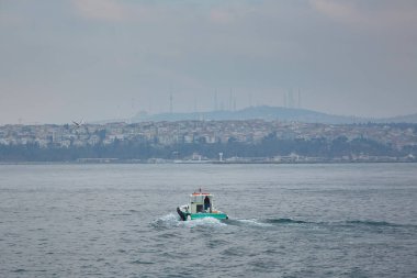 Tekne deniz boyunca sahile doğru yelken açar. Boğaz. Boğaz. İstanbul