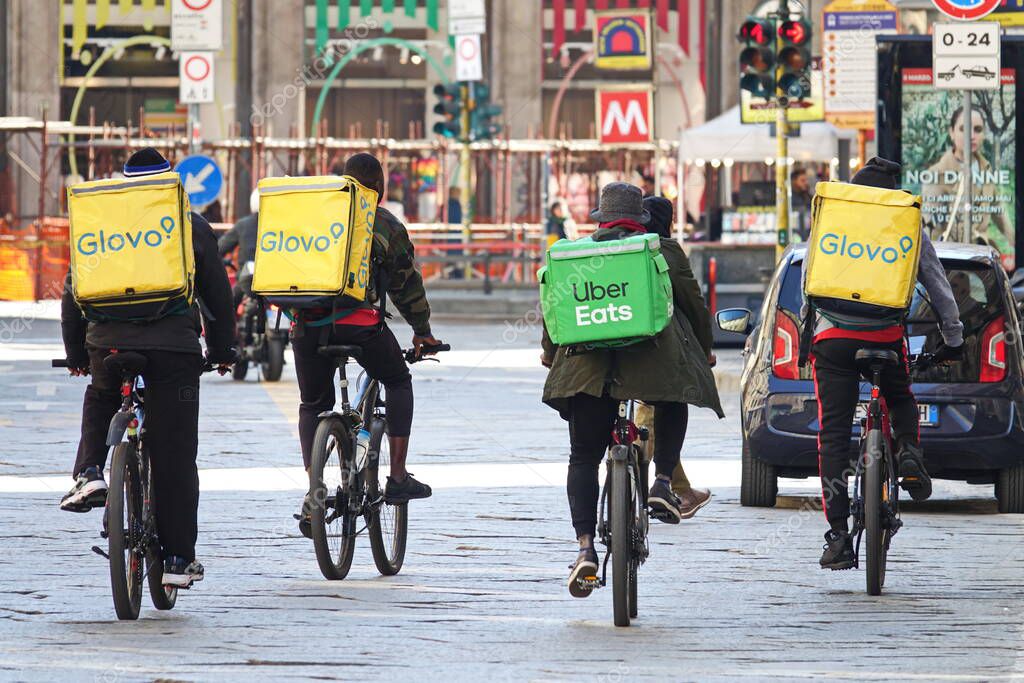 Riders of home delivery food at work. Milan, Italy - March 2020
