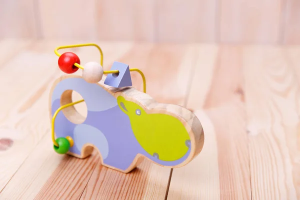 Wooden eco toys in the form of animals.Colorful toy made of wire with wooden details