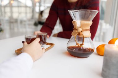 Bir fincan çay, bir daire, bir şube yaşayan bitki, mum olan bir portakal mandarin.winter atmosfere