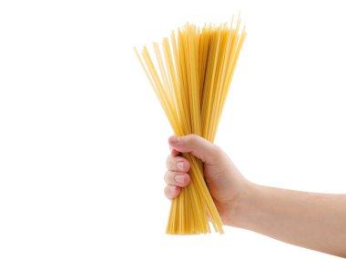 Hand holding raw spaghetti, hand is releasing the spaghetti. isolated on white background.woman holding uncooked fusilli pasta in his hands. Very short depth-of-field. clipart