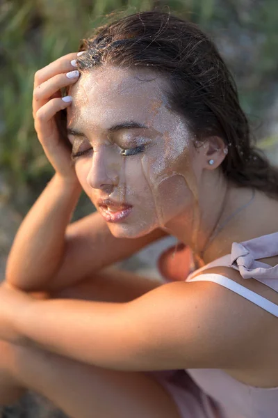 Young beautiful woman with honey on her face. Healthy perfect skin. Honey treatment.