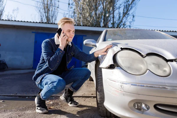 A man calling for help after a traffic accident on a mobile phone. Concept - car accident.