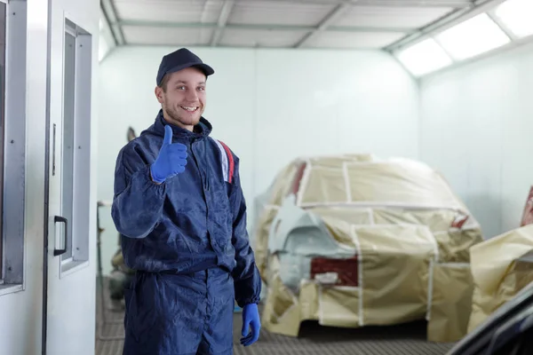 Joven Mecánico Taller Reparación Automóviles Muestra Pulgar Hacia Arriba Coche —  Fotos de Stock