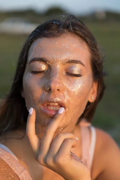 Young beautiful woman with honey on her face. Healthy perfect skin. Honey treatment.