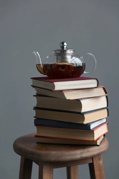 stack of books and tea pot