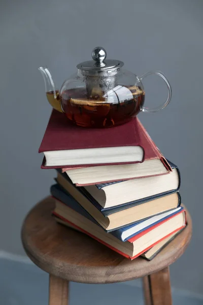 stack of books and tea pot
