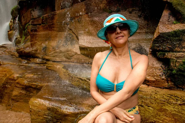 Lovely Lady Relaxing at one of the Many Waterfalls that are Found in Brazil