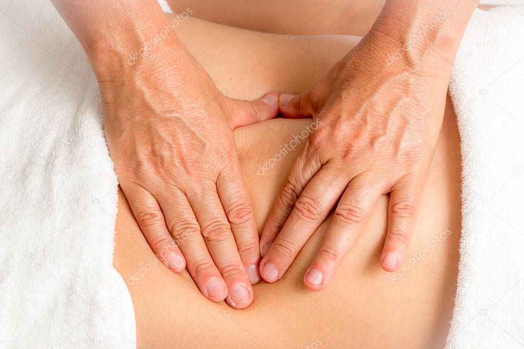 Massage Therapist Massaging a Woman's Stomach