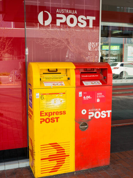 Melbourne, Australia - August 11, 2016: Australia Post standard and express post letterboxes in Box Hill. Australia Post is the publicly owned postal service provider.