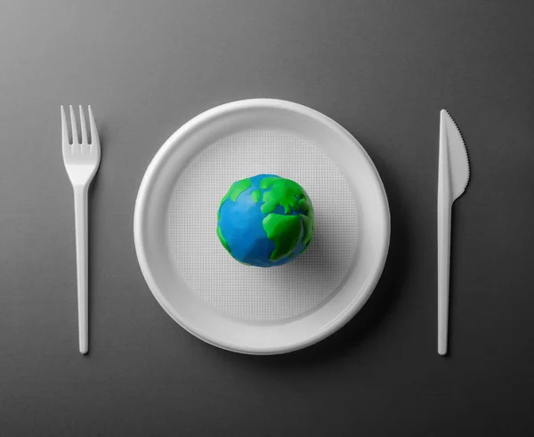 Serving Table Colored Earth Planet Black White Plastic Plate Fork — Stock Photo, Image