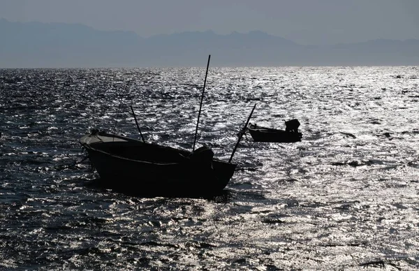 Evening landscape on Red Sea and fishing boats silhouette, Sinai seaside, Egypt.