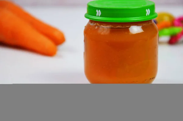 Baby Carrot Mashed Food Puree Spoon Glass Jar White Background — Stock Photo, Image