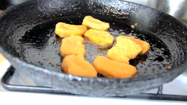 Girl fries chicken nuggets in a pan with butter. delicious homemade food. or fast food chicken breast nuggets — Stock Video