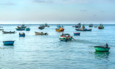 Mui Ne, Vietnam, April 23, 2018: Market early fishing village when people busy buying selling fish, transport fish to markets, all create an atmosphere of filthy beats cultural trade in Mui Ne, Vienam clipart