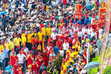 Binh Duong, Vietnam - 2 Mart 2018: Festival fener genç adam heykel Tanrıçalar taşıyan ve tütsü geçidi Caddesi üzerinde ziyaretçi çeken, bu Binh Duong, Vietnam için geleneksel Çin Festivali.