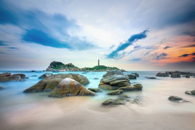 Ke Ga deniz feneri günbatımı okşadı sörf daha düzgün resifleri ile oluşturmak bulutlar deniz üzerinde