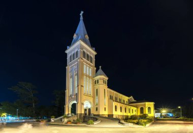 Da Lat, Vietnam - October 27th, 2018: Cathedral chicken at night. This is the famous ancient architecture, where attracts other tourists to annual spiritual culture in Da lat, Vietnam. clipart