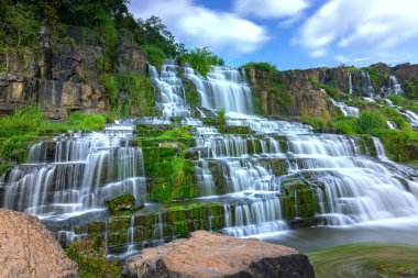 Mystical waterfall in the Da Lat plateau, Vietnam. This is known as the first Southeast Asian waterfall in the wild beauty attracted many tourists to visit clipart