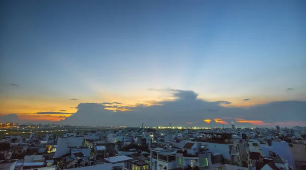 The sunset view in the urban area of the city when the sun has just turned off, the sparkling lights appear to adorn a perfect day