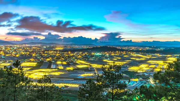 City night scene of a valley in Da Lat with greenhouses to plant flowers and vegetables. Blue hour moments when the sun sets it's time to light valley beauties adorn the romantic highland Vietnam