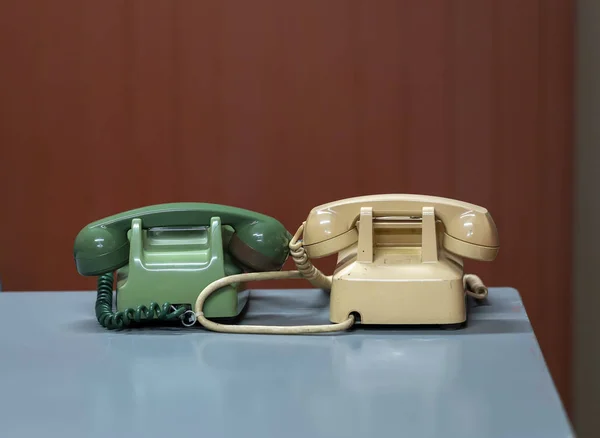 Old landline phone on the desk. They are manufactured from the 19th century as a means of communication by voice at that time