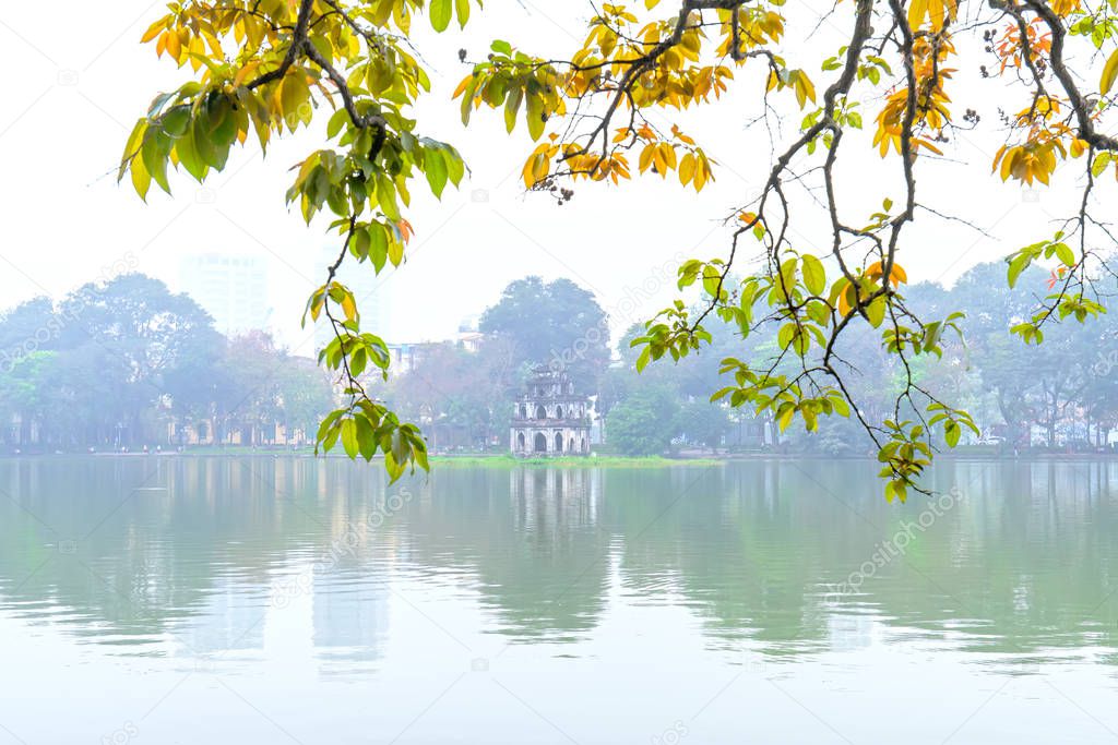 Tree in bud at Hoan Kiem lake in Hanoi Capital, Vietnam with Turtle Tower. This is an ancient architecture preserved to this day