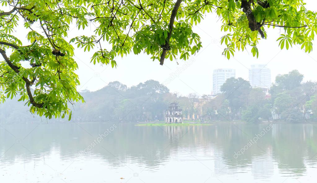 Tree in bud at Hoan Kiem lake in Hanoi Capital, Vietnam with Turtle Tower. This is an ancient architecture preserved to this day