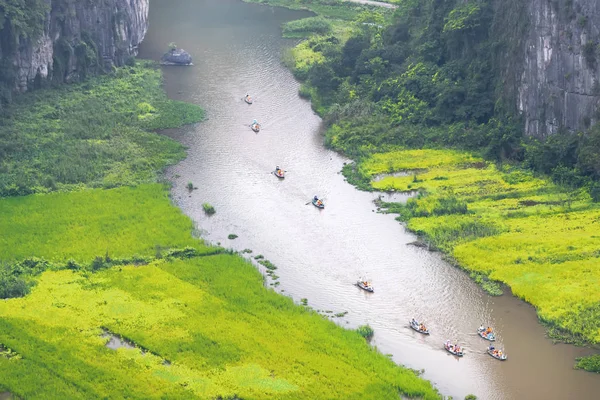 Tourist ride boat for sight seeing rice field on Ngo Dong river at Tam Coc, Ninh Binh, Vietnam