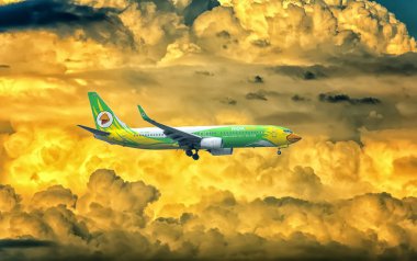 Ho Chi Minh City, Vietnam - May 29th, 2019: Passenger aircraft Boeing 737 of Nok Air fly over urban areas prepare to landing at Tan Son Nhat International Airport, Ho Chi Minh City, Vietnam. clipart