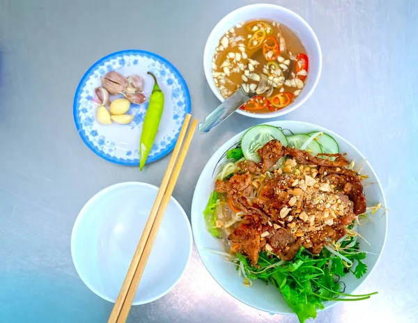 Rice vermicelli with grilled meat served with herbs, garlic chili sauce is the signature dish of Vietnam food