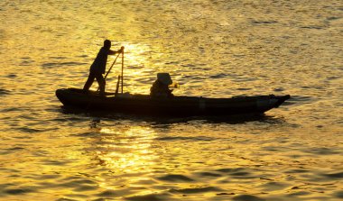Soc Trang, Vietnam - 29 Ocak 2019: Soc Trang, Vietnam'daki mekong Deltası'nda gün batımında kürek çekerek yolcuları nehir boyunca taşıyor
