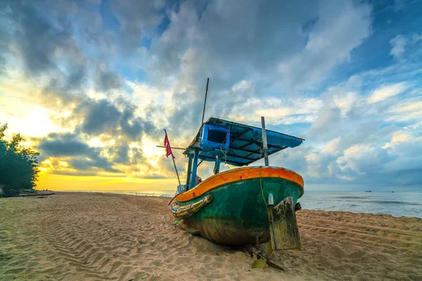 Fishing boat to dawn on the beautiful beach on a summer morning on a tropical beach near Mui Ne, Vietnam