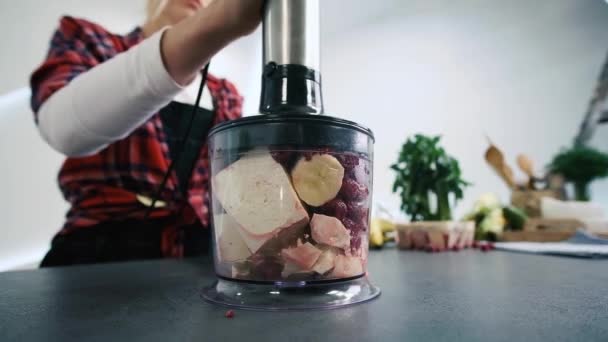 Fruits and berry with milk are blended up into a healthy red smoothie, banana and raspberry cocktail . Mix banana and berries in the blender. The concept of a healthy lifestyle. — Stock Video