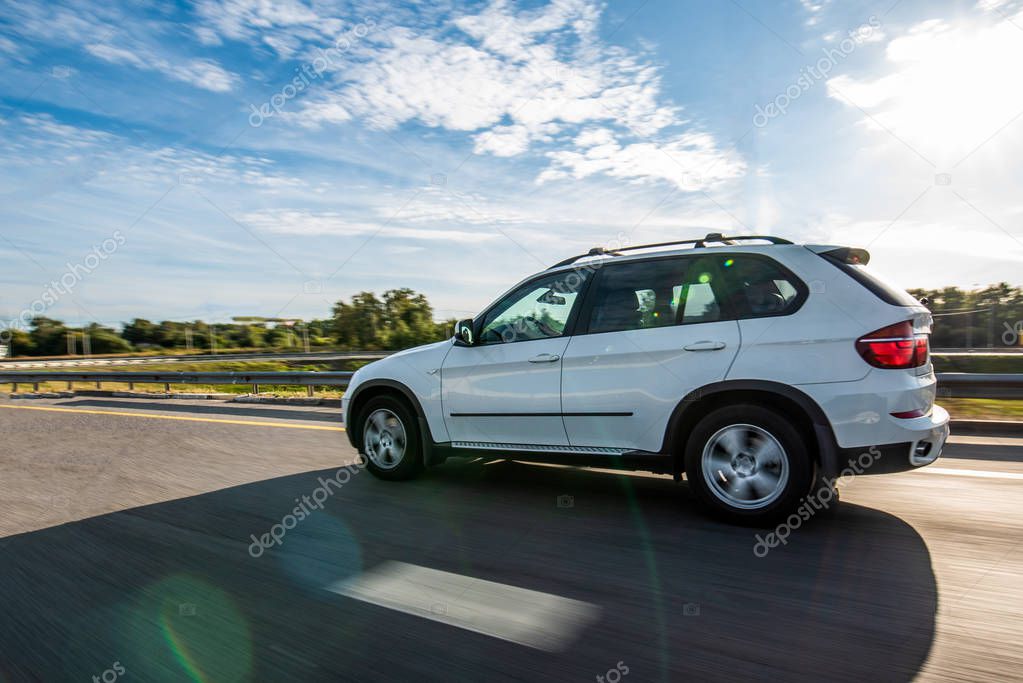 White suv on the road with speed effect