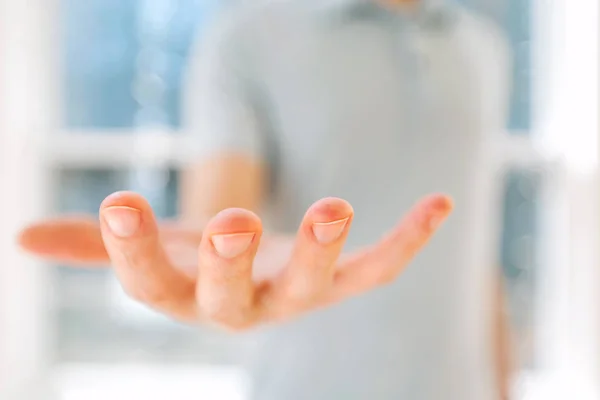 Man holding his hand out and showing something