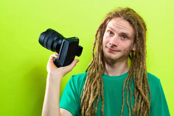 Młody mężczyzna, trzymając aparat profesjonalny — Zdjęcie stockowe