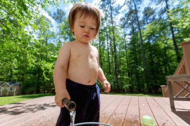 Su ile oynamak genç yürümeye başlayan çocuk