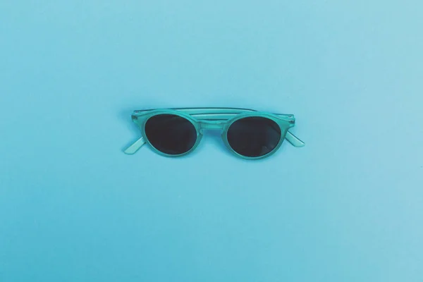 Occhiali da sole freddi su uno sfondo blu bambino — Foto Stock