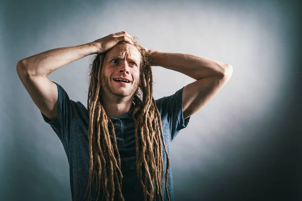 Jovem sentindo-se estressado em um fundo sólido — Fotografia de Stock