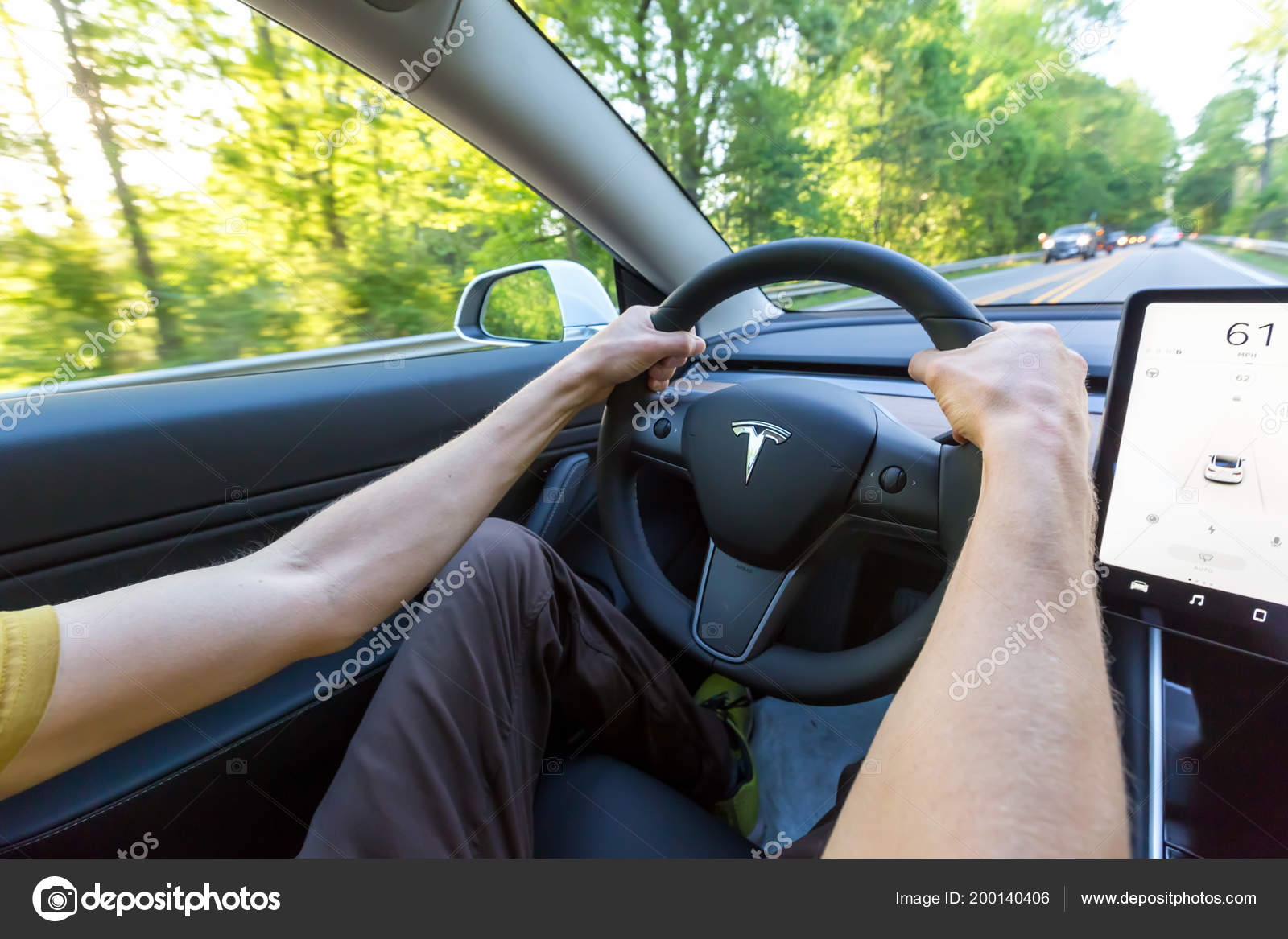 Person Driving A New Tesla Model 3 Stock Editorial Photo