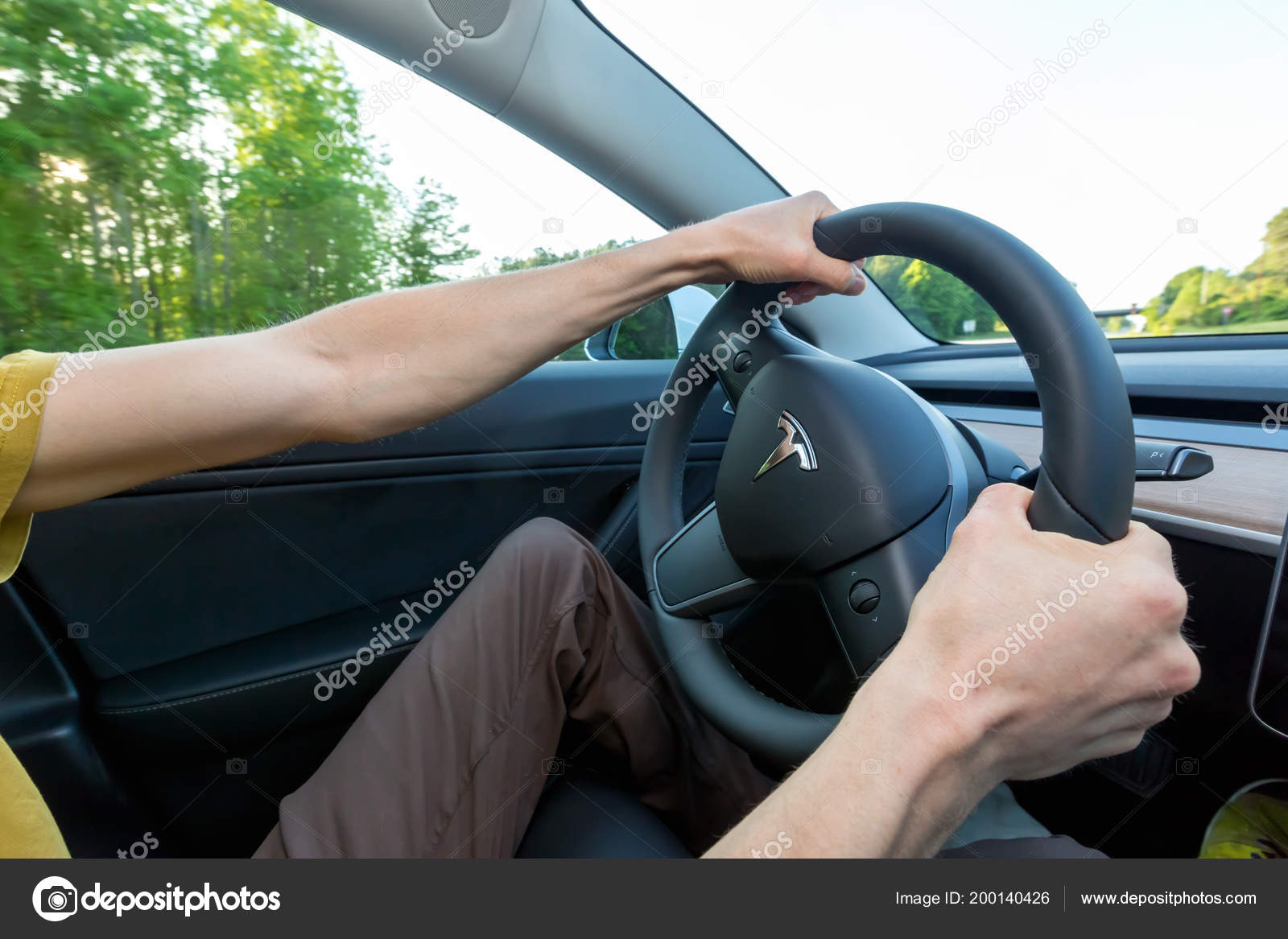 Person Driving A New Tesla Model 3 Stock Editorial Photo