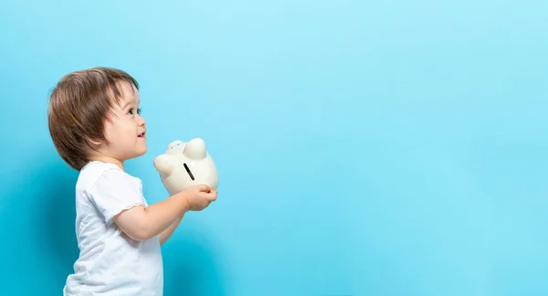 Toddler boy with a piggy bank — Stock Photo, Image