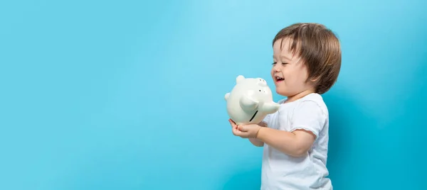 Toddler boy with a piggy bank — Stock Photo, Image