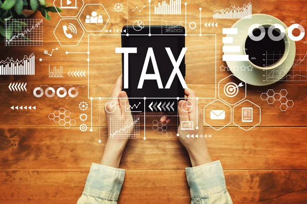 Tax with a person holding a tablet — Stock Photo, Image