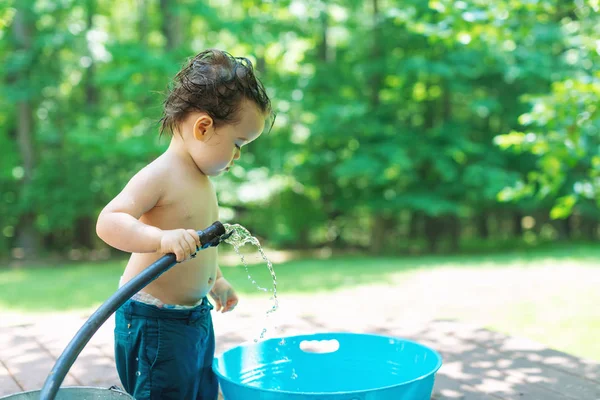 Young toddler boy playing with water — Stock Photo, Image