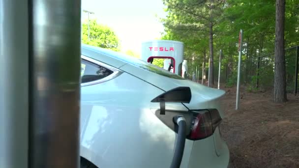 Opladning af en Tesla Model 3 på en Tesla Supercharger station i Raleigh, NC . – Stock-video